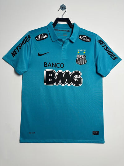 Camiseta Polo Santos FC 2012 Edición Especial Nike, azul celeste, con escudo bordado y logotipos de patrocinadores.