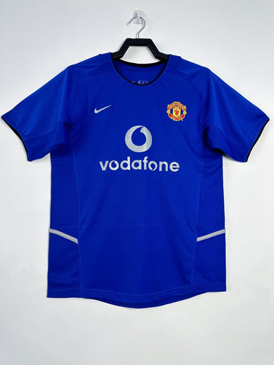 Manchester United 2002-2003 away jersey by Nike in blue with Vodafone logo.