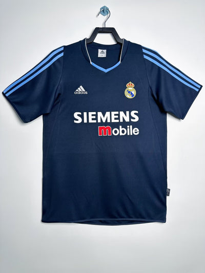 Camiseta Real Madrid 2003-2004 azul marino, diseñada por Adidas, con patrocinador Siemens Mobile y tecnología ClimaCool.