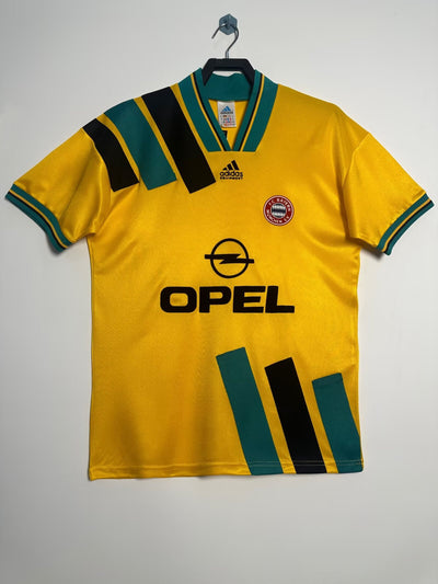 Camiseta retro Bayern Múnich 1993-1994 Adidas con patrocinio Opel, amarillo vibrante, detalles en verde y negro.