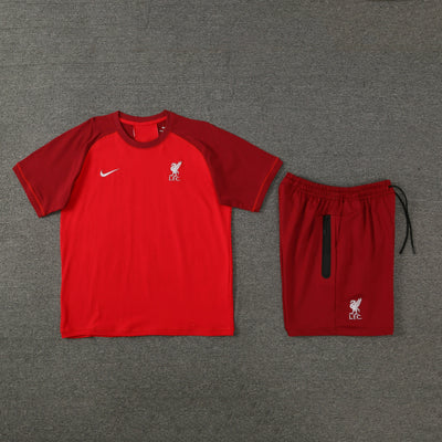 Red short sleeve T-shirt and shorts set on grey background.