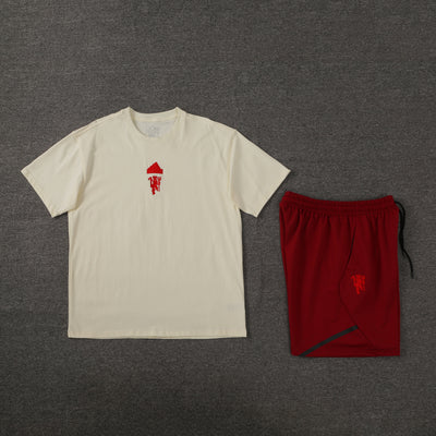 Short sleeve T-shirt with matching red shorts set on gray background.